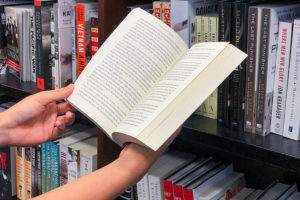 Man looking through books at a book store